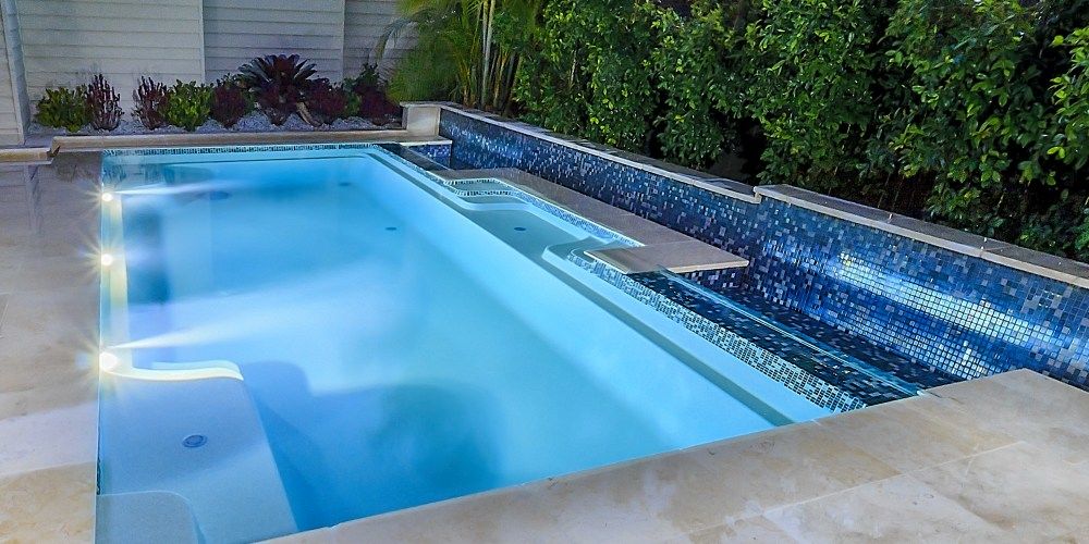 Vogue fibreglass pool installation with seating area